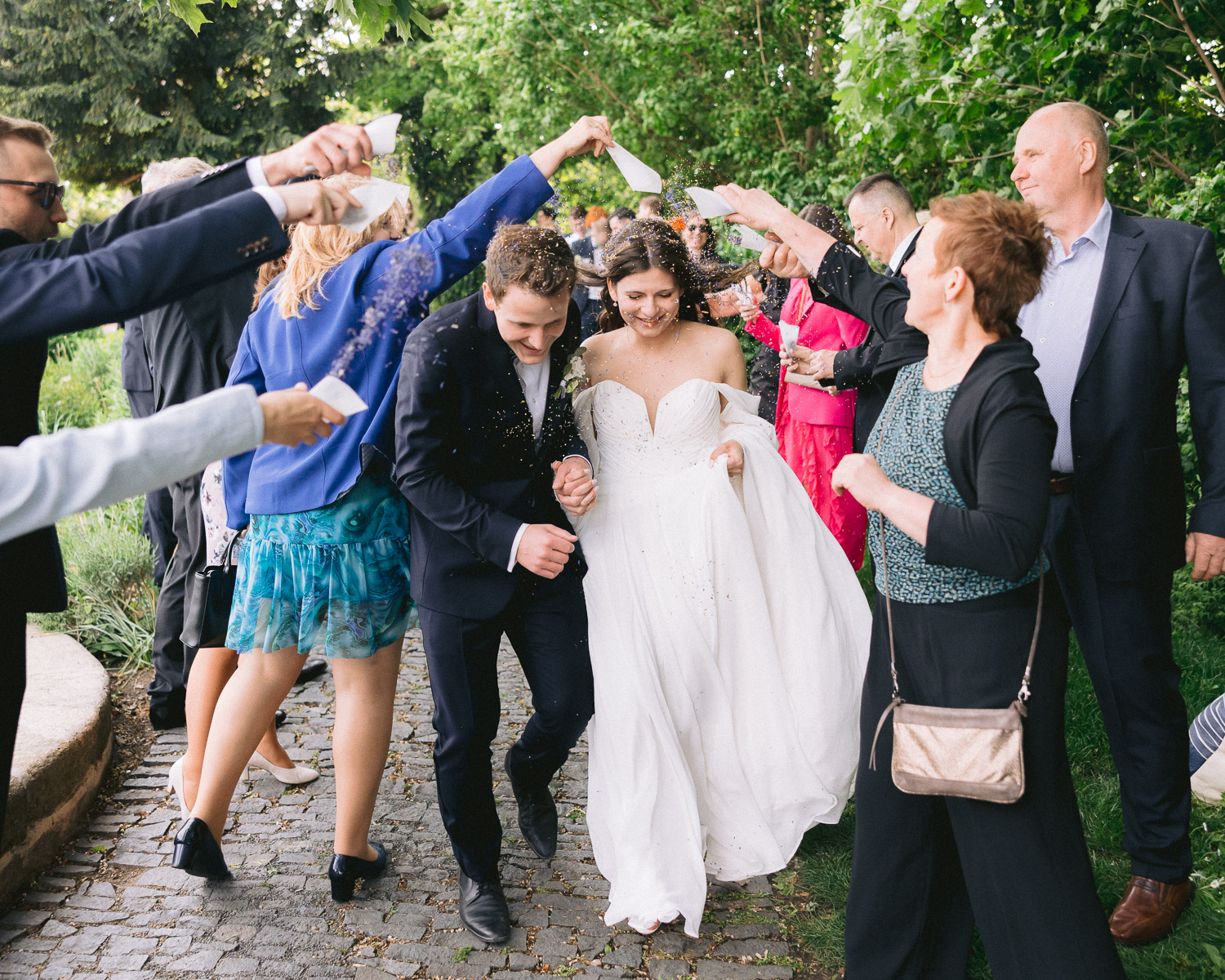 Guests forming an arch for the newlyweds