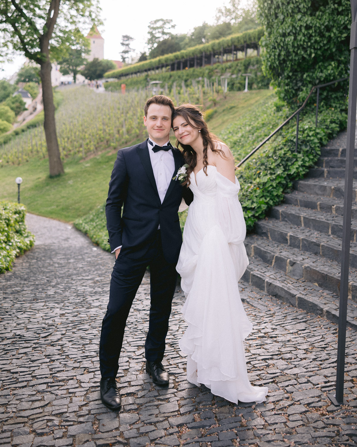 Bride and groom on the stone steps through the vineyard at Villa Richter