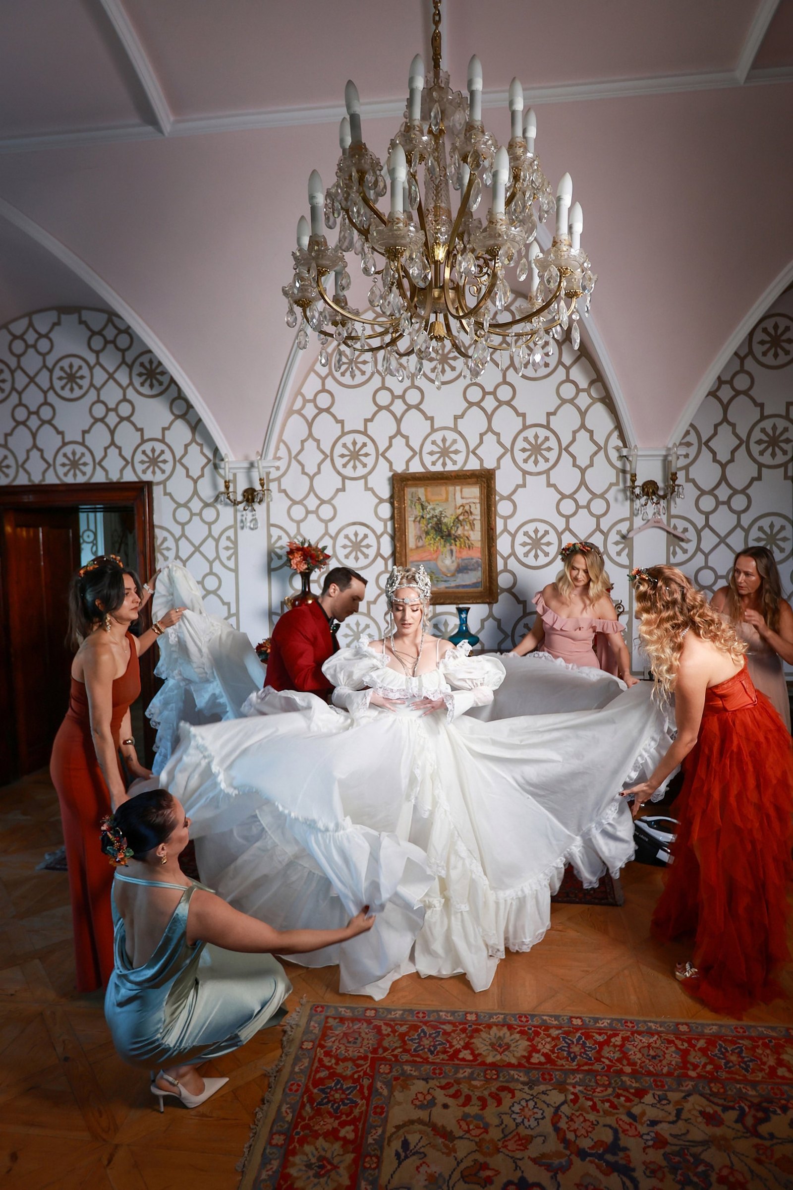 Bride-getting-ready-chateau-chandelier Bride getting ready with her bridesmaids under a chandelier