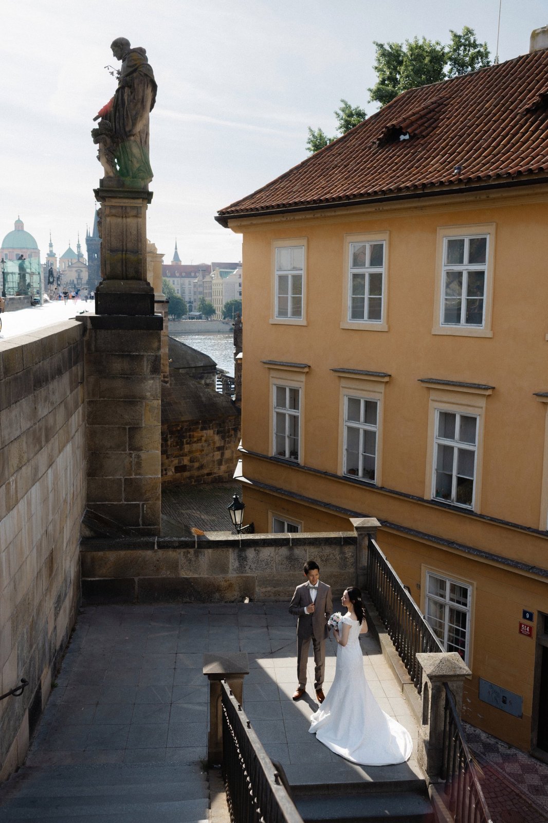 Charles-bridge-stairs-couple Couple on the stairs below Charles Bridge