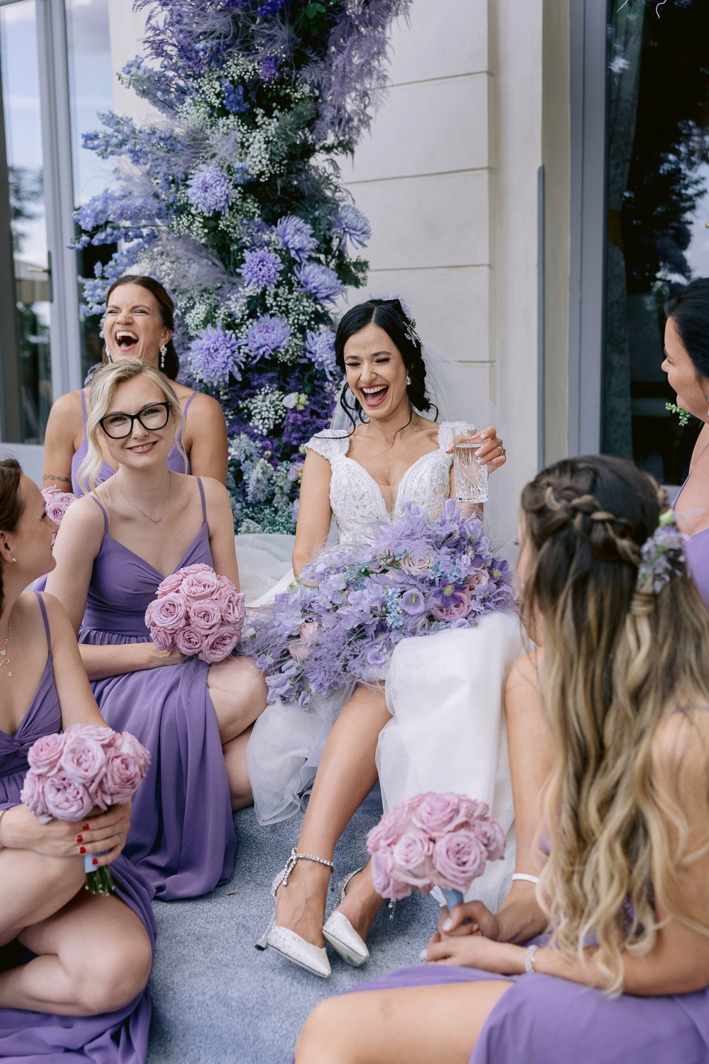 Chateau Mcely Bride Bridesmaids Laughing Bride laughing with her bridesmaids in lilac dresses