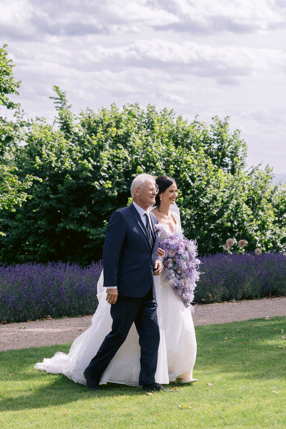 Chateau Mcely Father Walks Bride Down Aisle Father walking the bride down the aisle past the lavender
