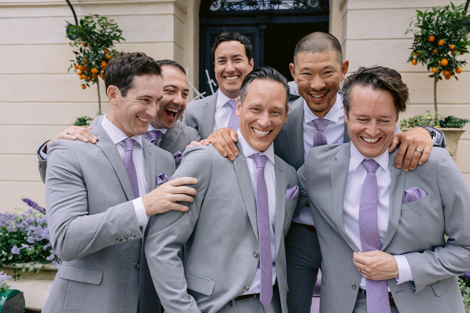Chateau Mcely Groom Groomsmen Laughing Groom laughing with his groomsmen in front of Château Mcely