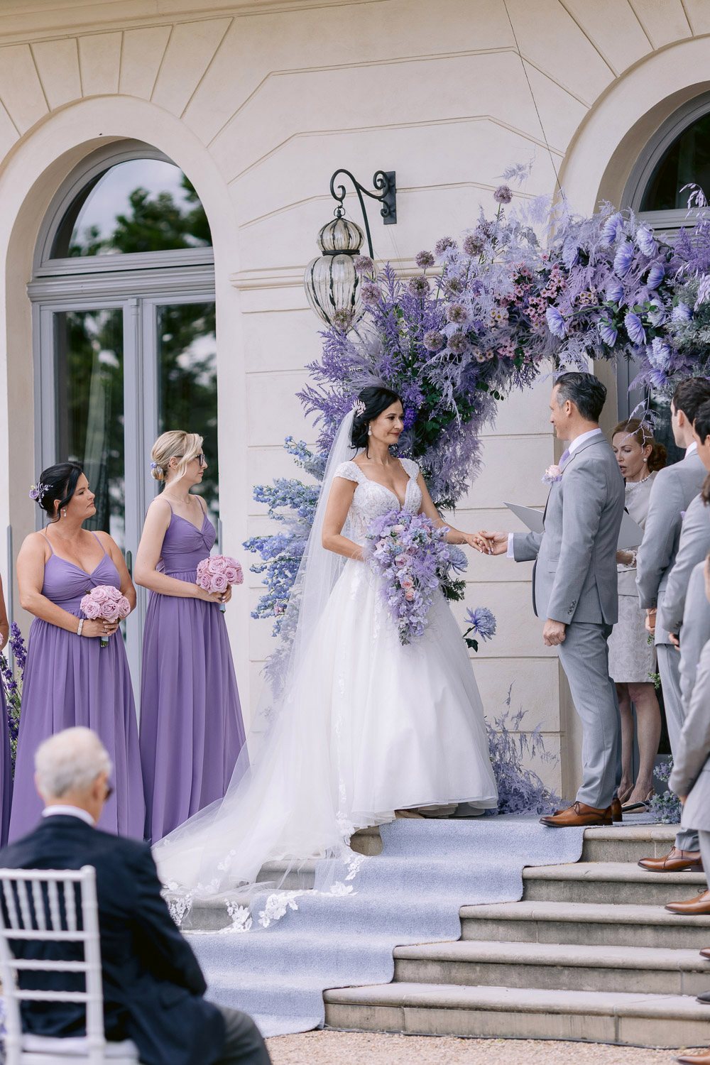 Chateau Mcely Wedding Ceremony Flower Arch Wedding ceremony under a lavender flower arch on the château steps