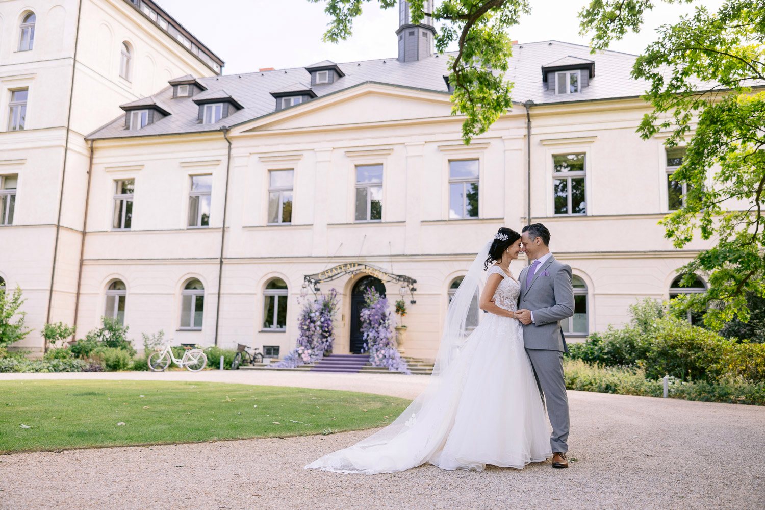 Chateau Mcely Wedding Couple Front Of Chateau Bride and groom in front of Château Mcely with the lavender flower arch