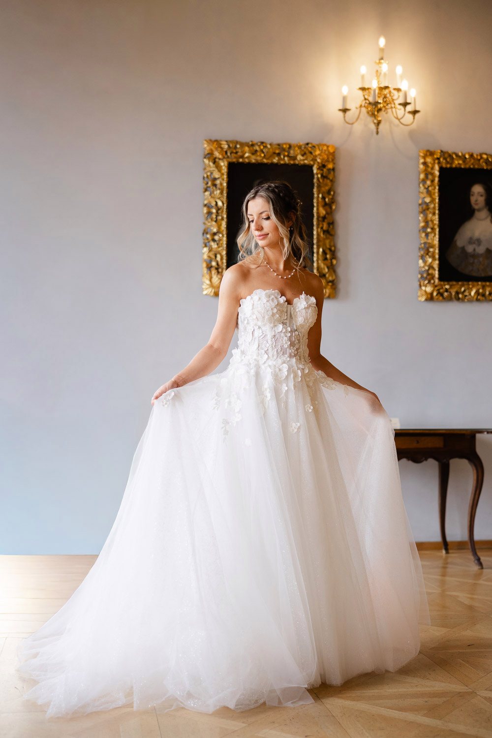 Lobkowicz Palace Elopement Bride Palace Hall Bride holding her dress in a palace hall with old portraits