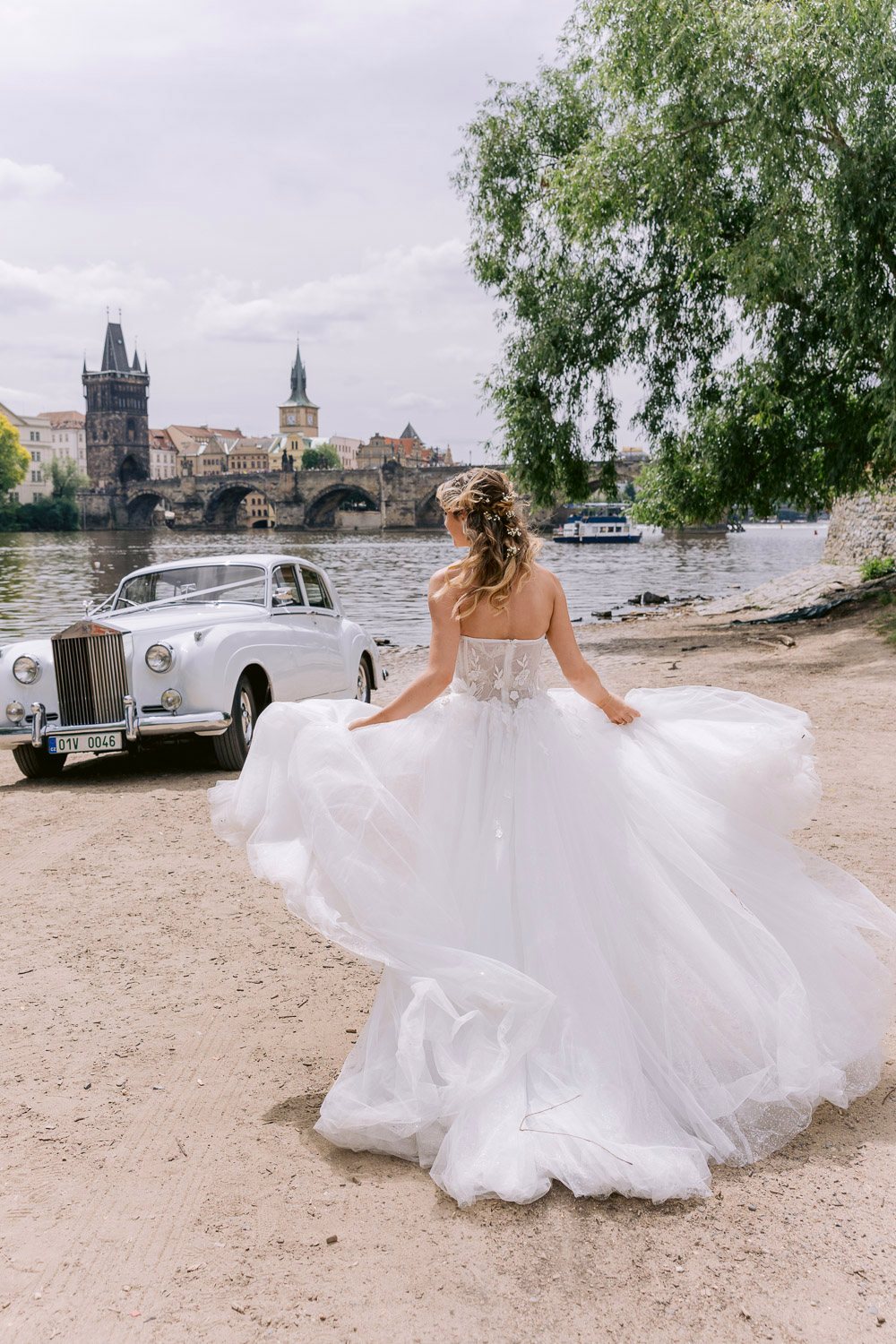 Lobkowicz Palace Elopement Bride Twirl Vltava Bride twirling her skirt on the Vltava bank