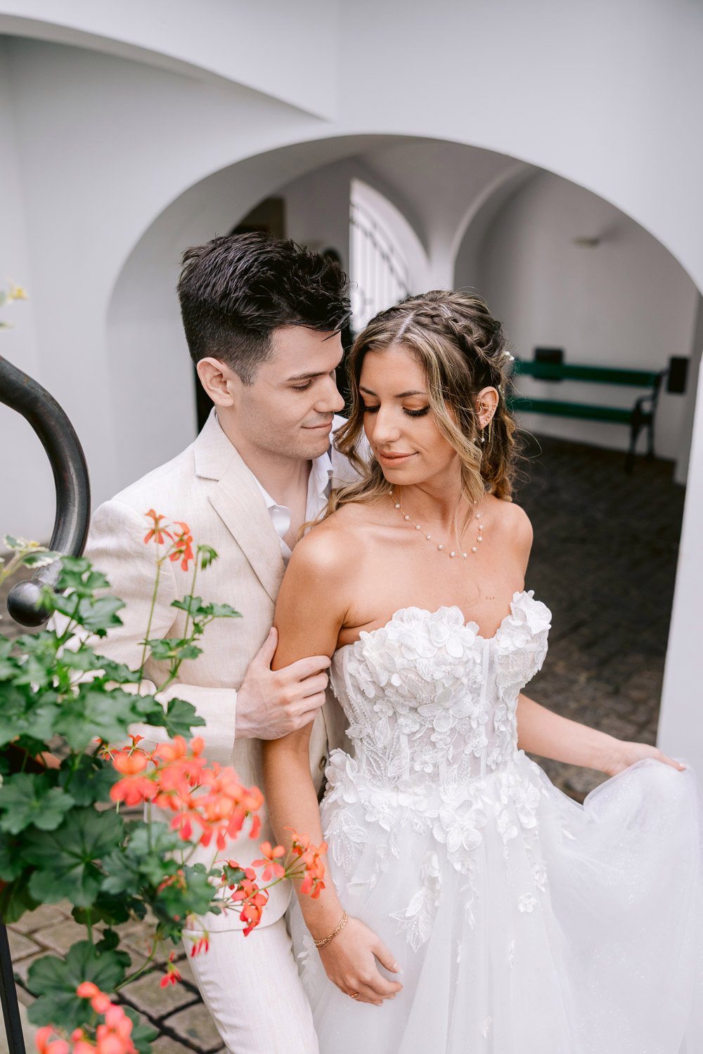 Lobkowicz Palace Elopement Couple Courtyard Flowers Couple close together by the flowers in the courtyard