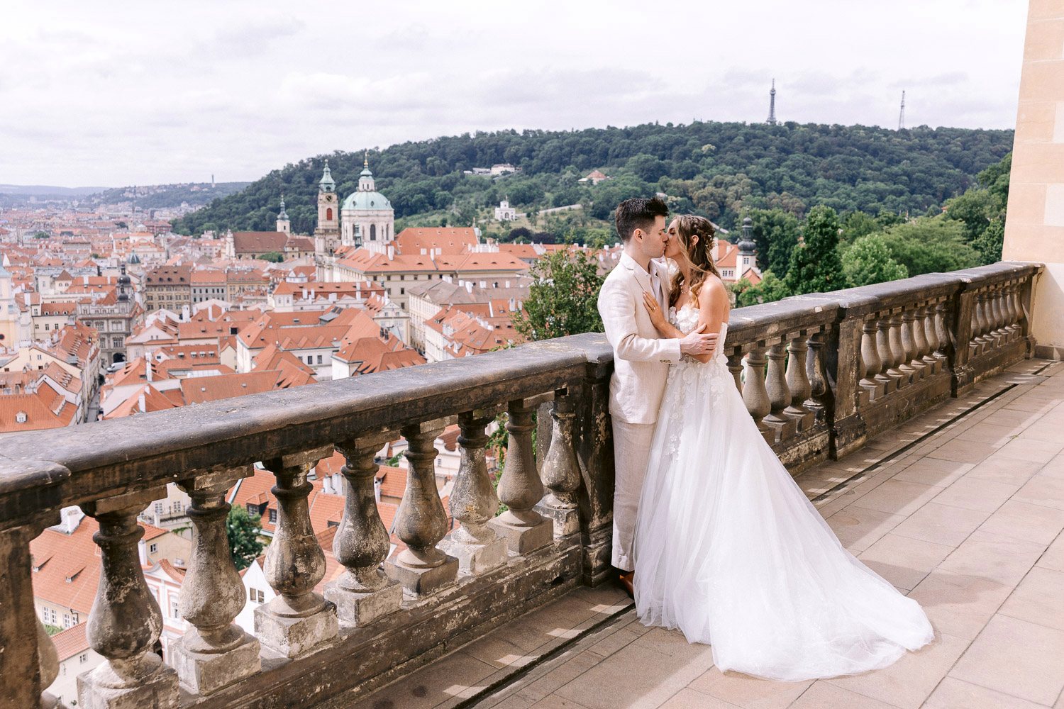 Lobkowicz Palace Elopement Couple Kiss Balustrade Newlyweds kissing at the terrace balustrade