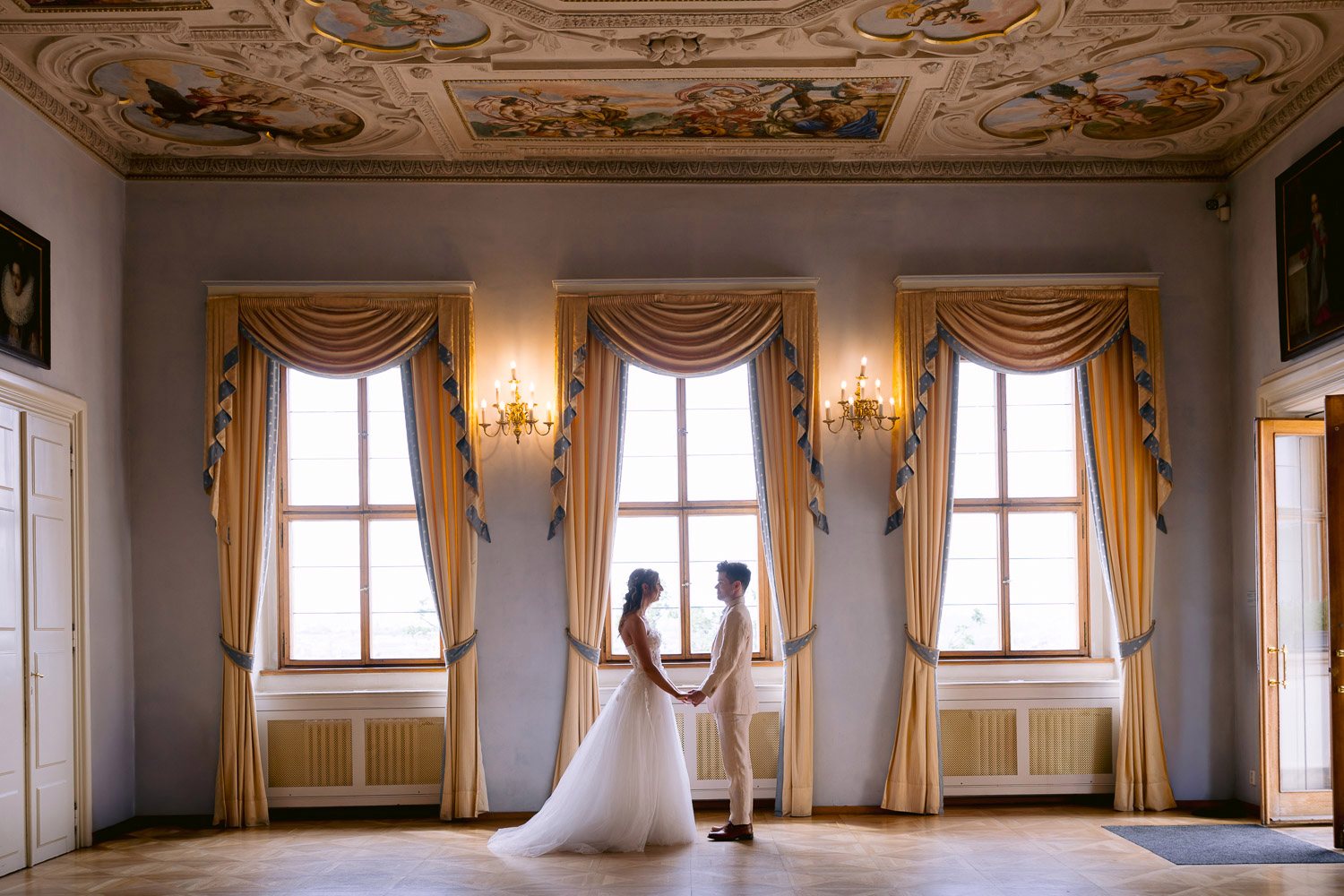 Lobkowicz Palace Elopement Couple Palace Hall Windows Couple by the tall windows of a palace hall