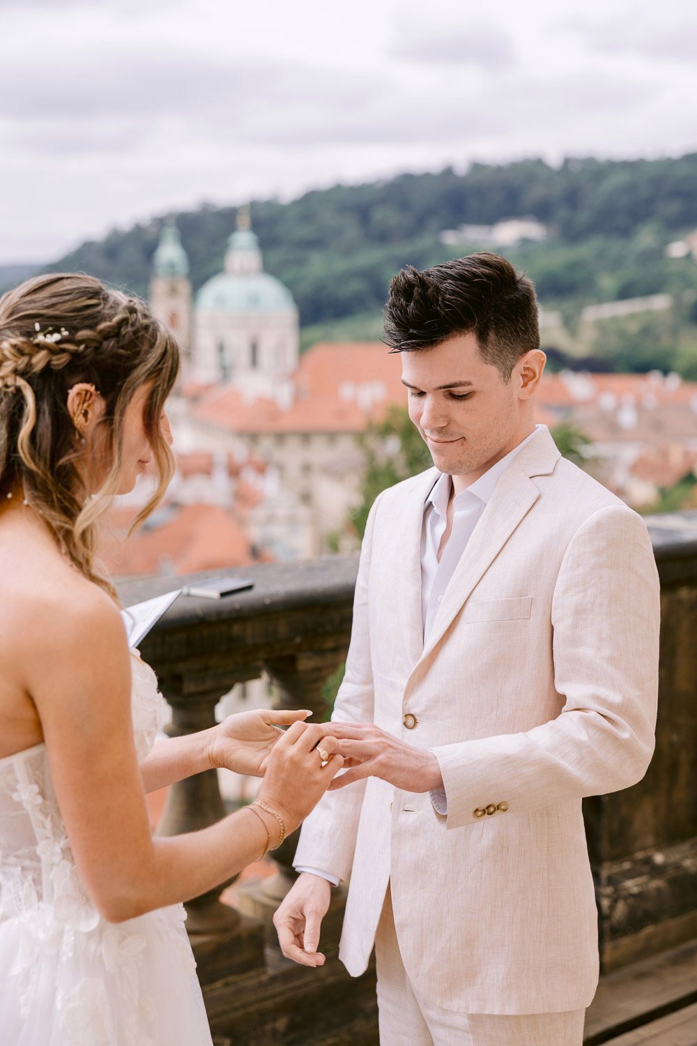 Lobkowicz Palace Elopement Ring Exchange Prague View Ring exchange with St Nicholas Church behind