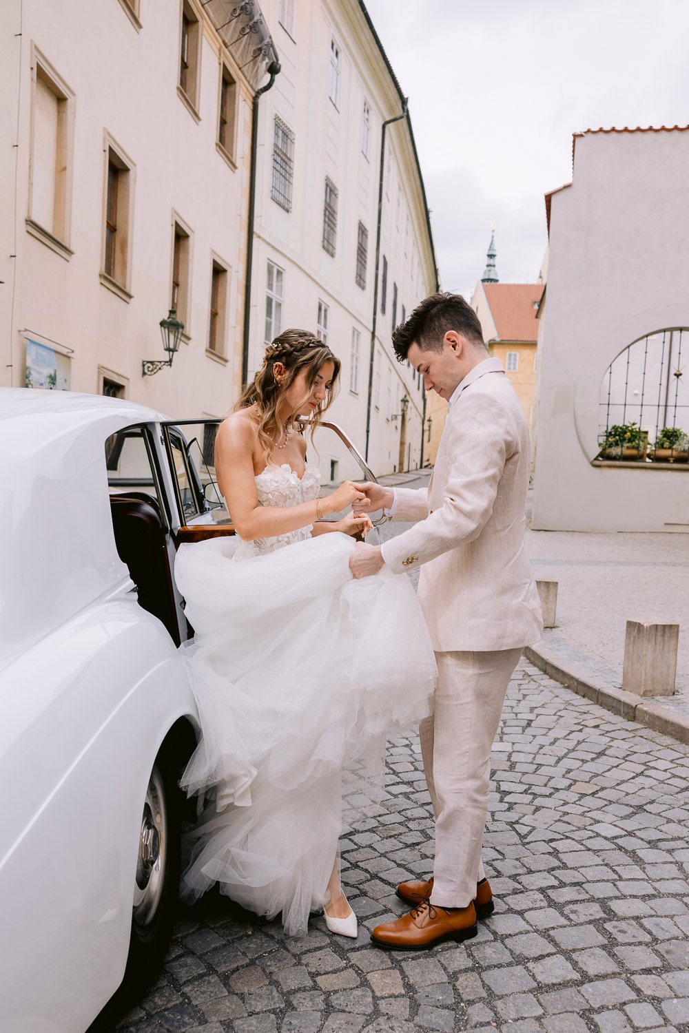 Lobkowicz Palace Elopement Rolls Royce Arrival Groom helping the bride out of the Rolls-Royce