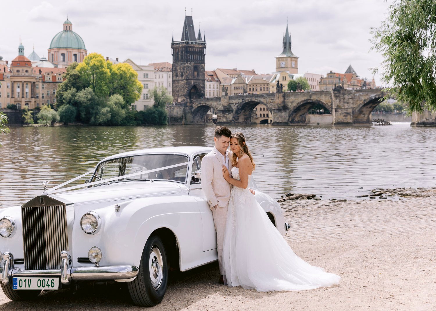 Lobkowicz Palace Elopement Rolls Royce Vltava Charles Bridge Vintage Rolls-Royce on the Vltava bank facing Charles Bridge