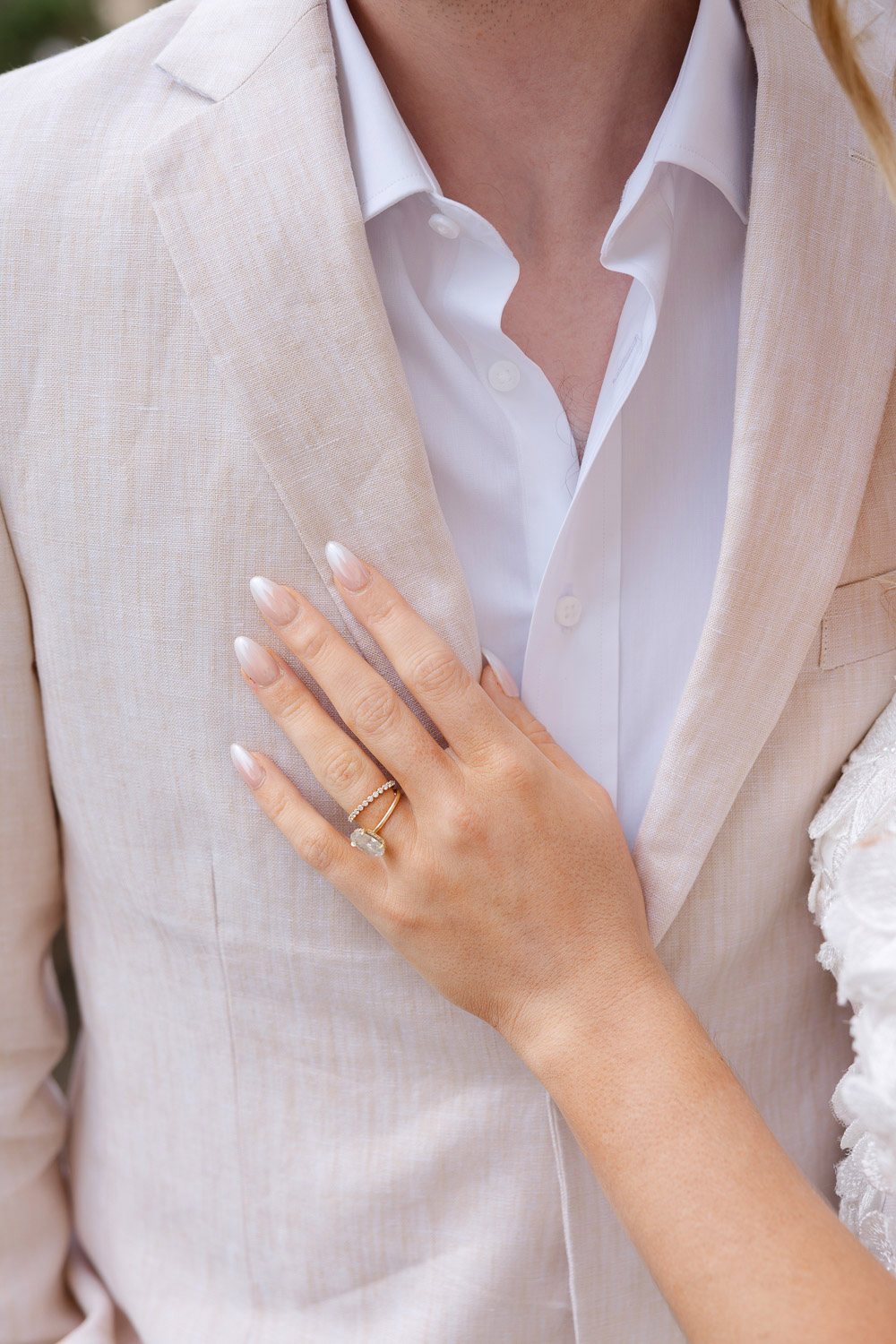 Lobkowicz Palace Elopement Wedding Ring Hand Detail Bride's hand with her new ring on the groom's jacket