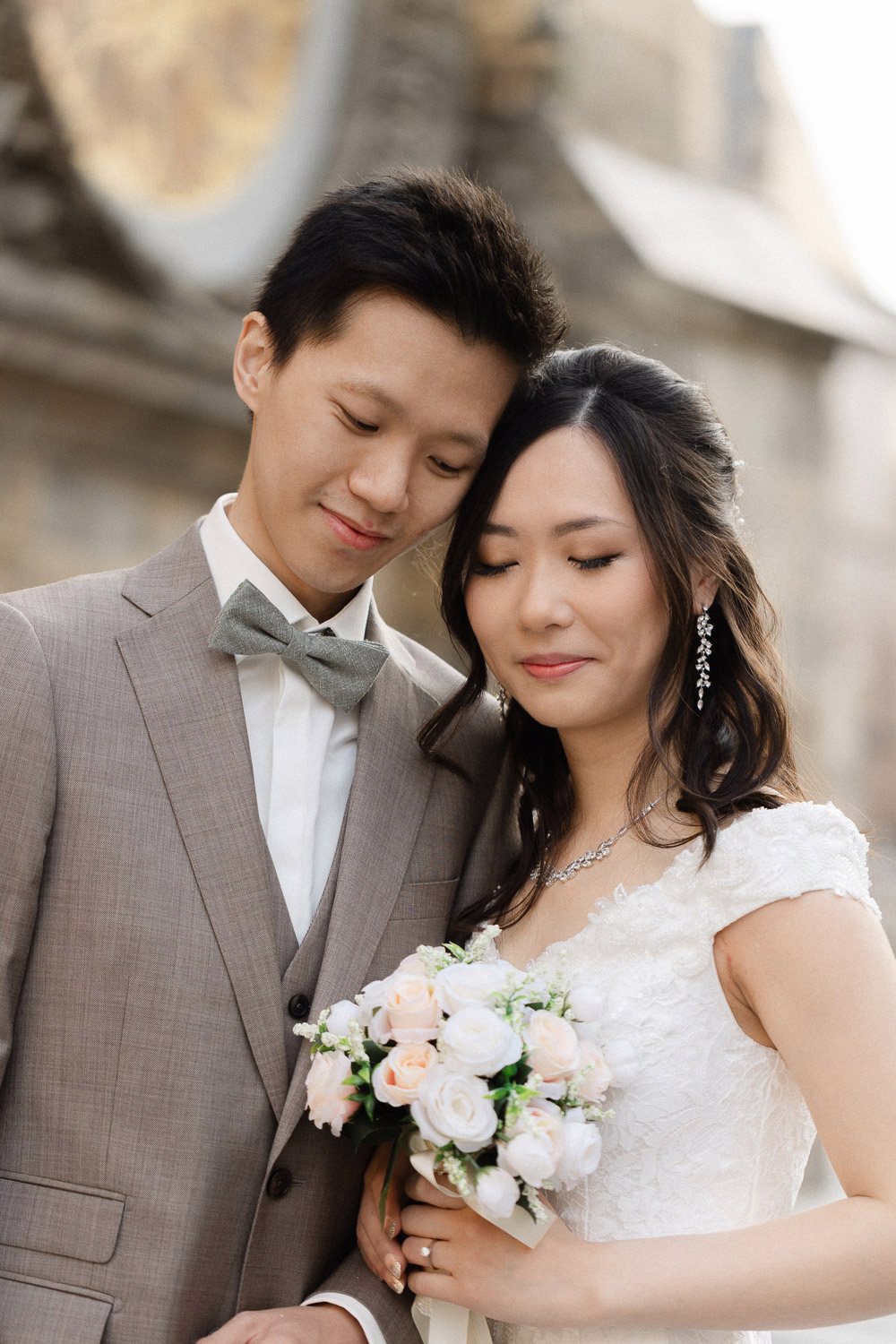 Bride with her bouquet resting on the groom
