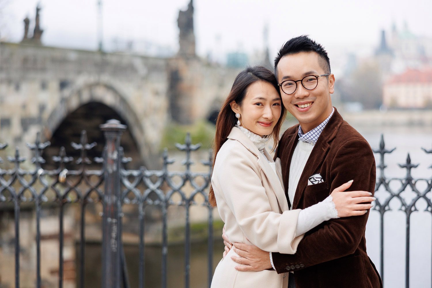 Couple by the railing near Charles Bridge