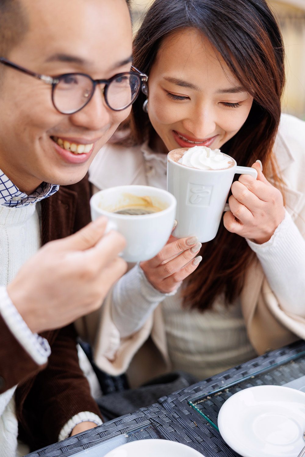 Couple enjoying hot drinks at a café
