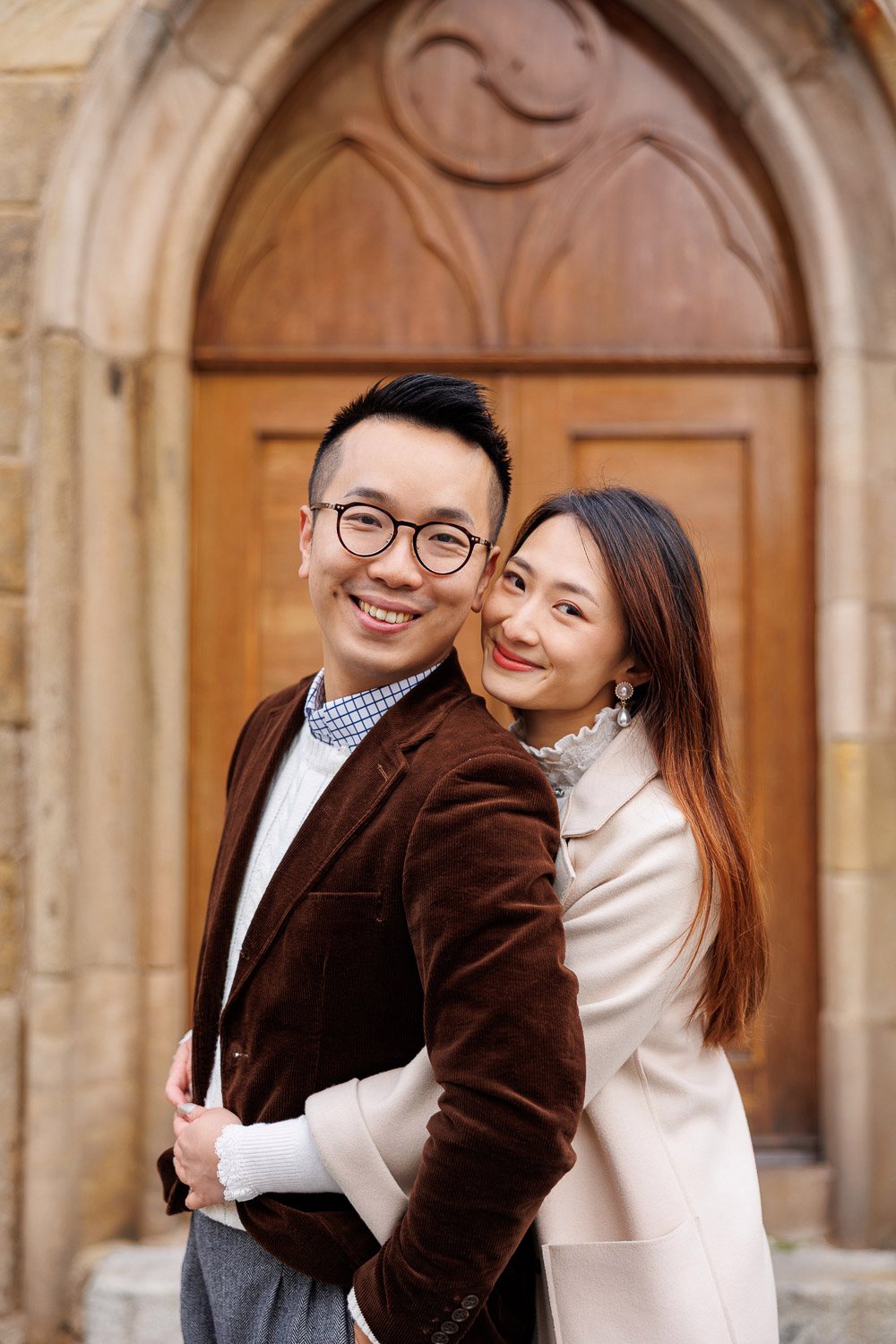 Couple in front of a Gothic wooden door