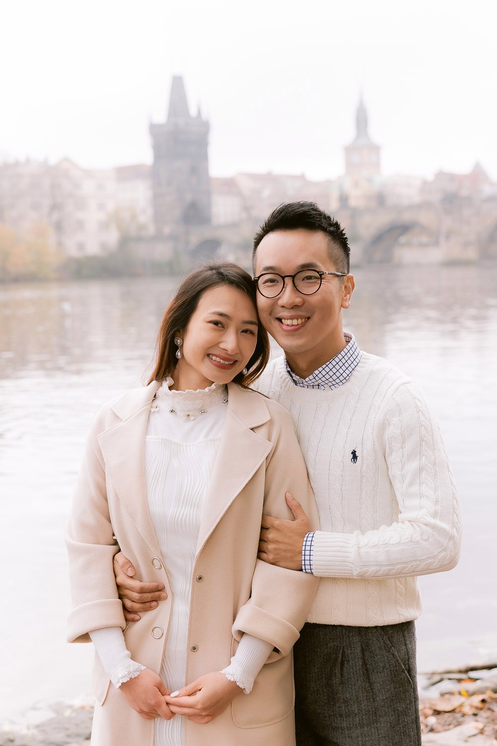 Couple on the Vltava riverbank in autumn