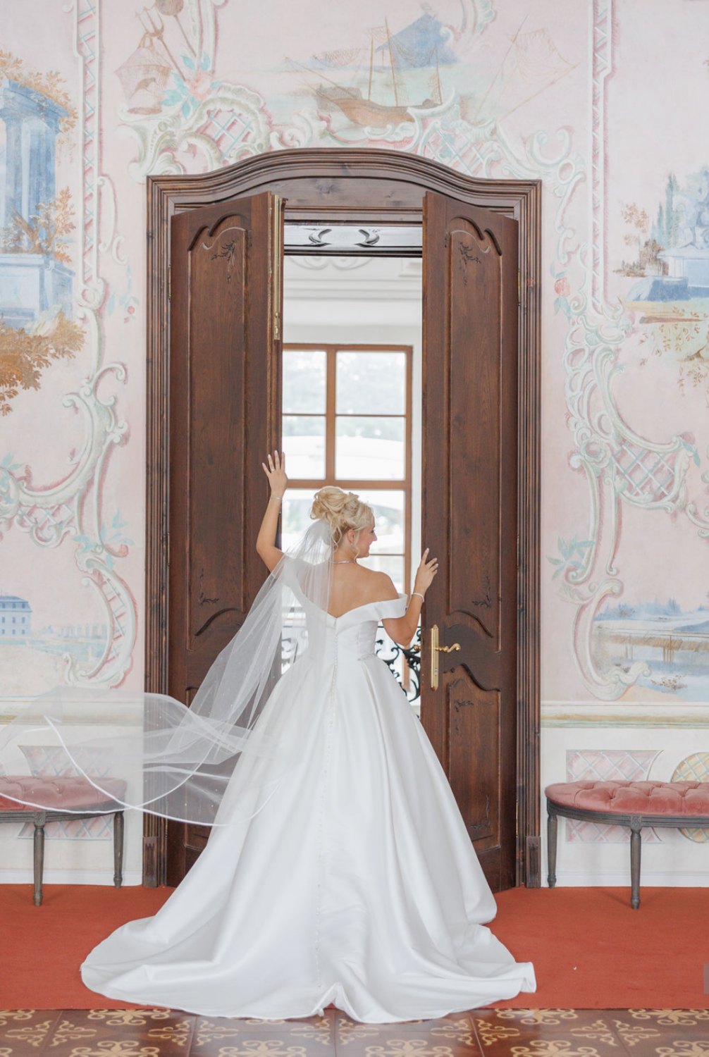 Review Veronika Chateau Wedding 2 Bride walking through a painted château doorway