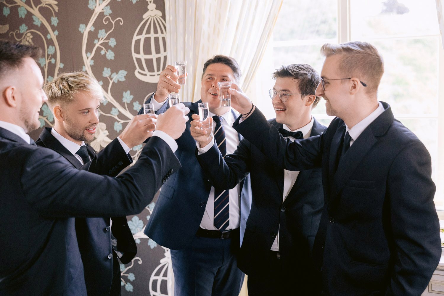 Villa Richter Groom Groomsmen Toast Groom and groomsmen raising a toast