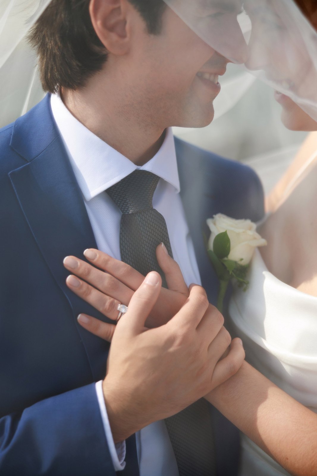 Wedding-hands-veil-detail Bride and groom holding hands under the veil